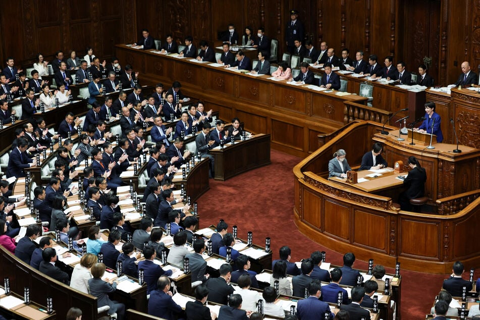 Japanese parliament members listen as Prime Minister Sanae Takaichi delivers her first policy speech on October 24, 2025.