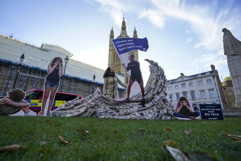 A campaigner protesting against Mark Zuckerberg outside the Houses of Parliament ahead of Haugen's testimony.