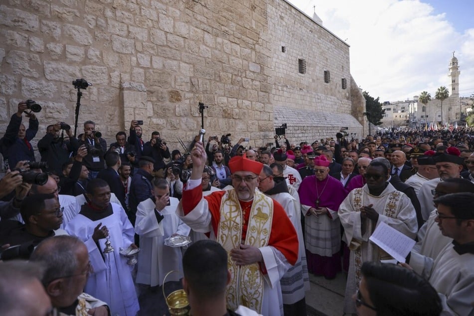 Latin Patriarch of Jerusalem Pierbattista Pizzaballa leads the yearly Christmas procession outside the Church of the Nativity in Bethlehem in the Israeli-occupied West Bank on December 24, 2024.