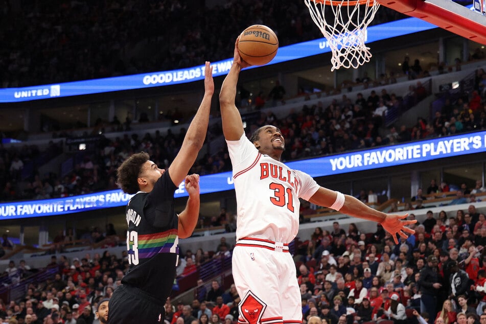 Jaden Ivey of the Chicago Bulls attempts a dunk against Cameron Johnson of the Denver Nuggets during the second quarter at the United Center on February 7, 2026.