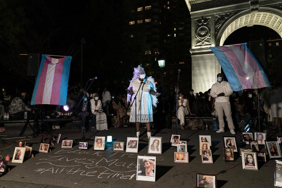 Washington Square, 2020: people held a vigil on transgender day of remembrance to commemorate the lives of transgender victims of violence, as their pictures sat on display.