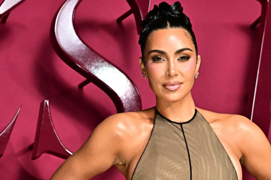 Kim Kardashian laughed off the buzz around her news SKIMS "Ultimate Bush" underwear while turning heads in a stunning gown at the All's Fair premiere.