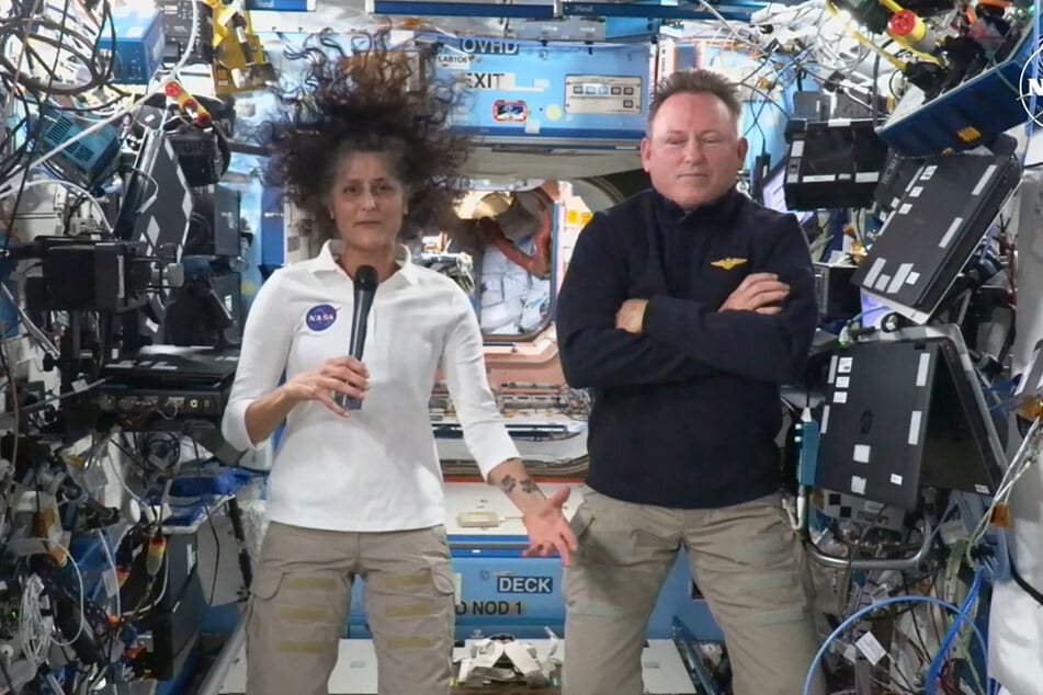 In this still image taken from a NASA TV broadcast, NASA astronauts Butch Wilmore (r.) and Suni Williams (l.) hold a news conference from the International Space Station (ISS) on September 13, 2024.