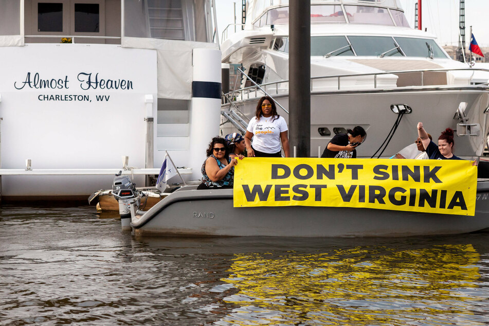 West Virginians protest at Senator Joe Manchin's houseboat, Almost Heaven, in the Washington marina.