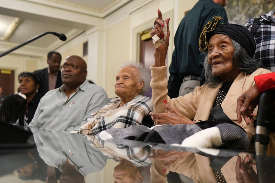 Over a century after the 1921 Tulsa Race Massacre, Lessie Benningfield Randle (r.) is fighting for accountability and repair alongside fellow survivor Viola Ford Fletcher (c.). Both women are 109 years old.