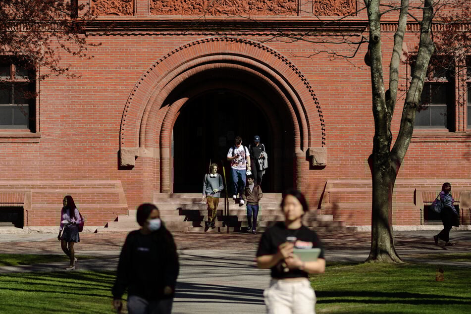 People cross the Harvard Yard at Harvard University on April 17, 2025 in Cambridge, Massachusetts.