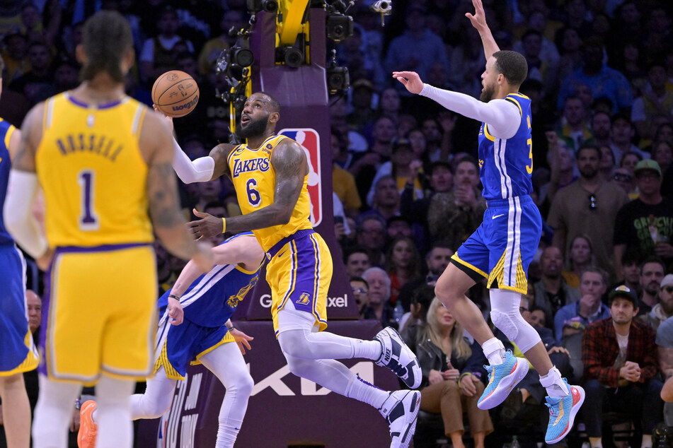 Los Angeles Lakers forward LeBron James goes for a shot after he was fouled by Golden State Warriors guard Stephen Curry in the second half of Game 6 of the 2023 NBA playoffs at Crypto.com Arena.