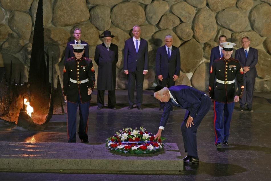 Biden lays a wreath of flowers at the Hall of Remembrance of the Yad Vashem Holocaust memorial museum in Jerusalem.