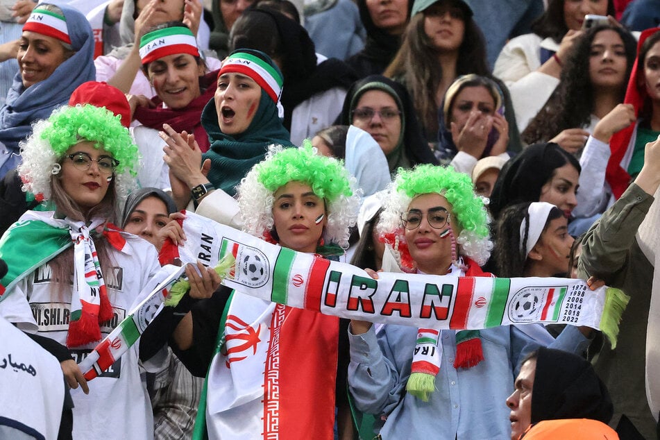 Iran supporters cheer during the FIFA World Cup 2026 Asia zone qualifiers group A match against North Korea at the Azadi Sports Complex in Tehran on June 10, 2025.