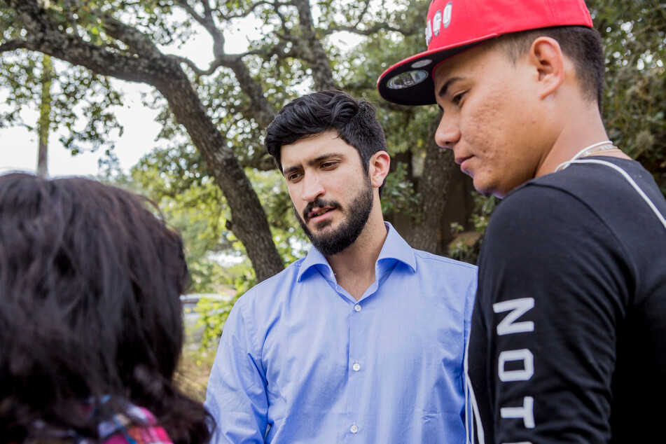 Texas-35 congressional candidate Greg Casar (c.) speaks with constituents in Austin.