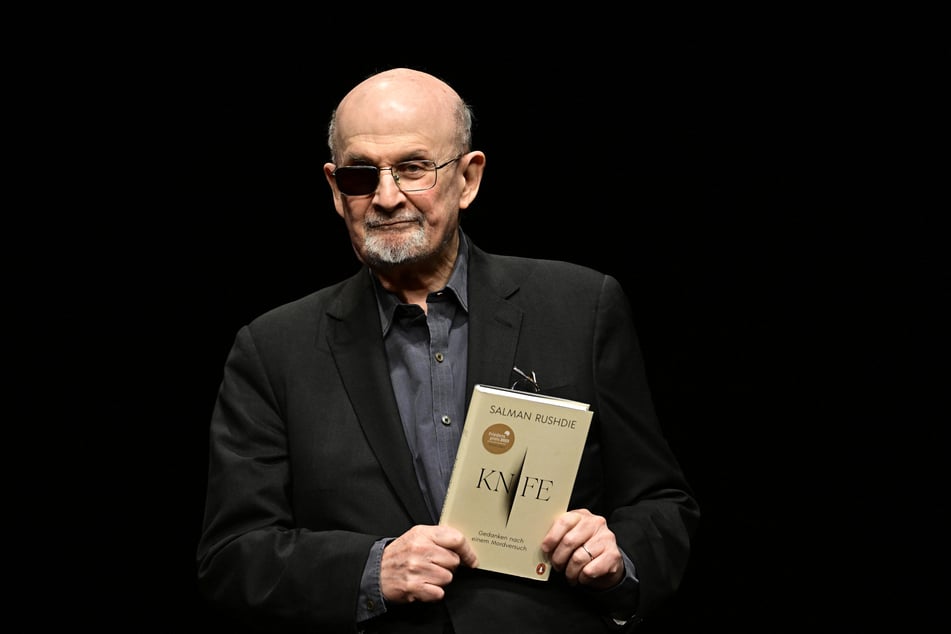 Indian-British novelist Salman Rushdie reacts on stage prior to a lecture from his book Knife: Meditations After an Attempted Murder, in Berlin on May 16, 2024.