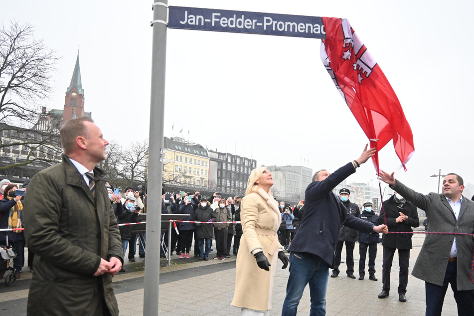 Marion Fedder, Innensenator Andy Grote, Umweltsenator Jens Kerstan und Bezirksamtsleiter Ralf Neubauer enthüllen das Schild der neuen Jan-Fedder-Promenade.