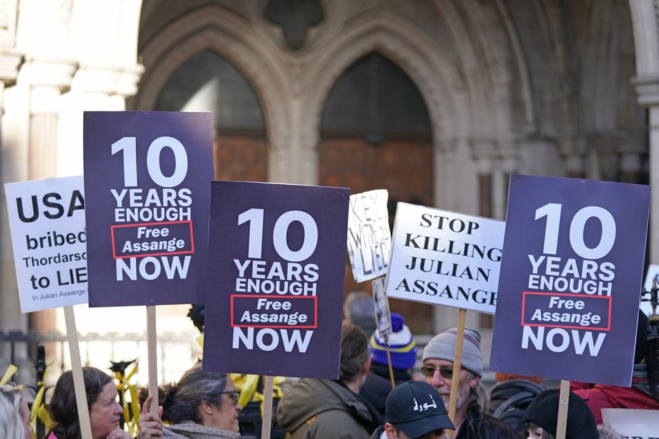 Supporters of Julian Assange demonstrate outside the Royal Courts of Justice in London.