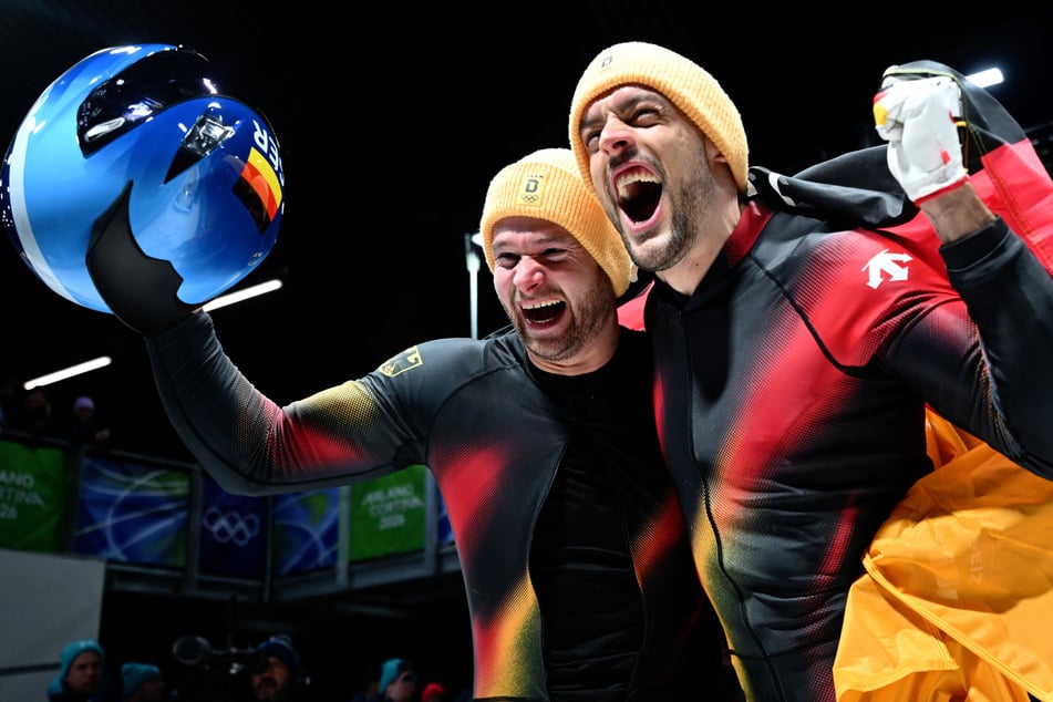 Pilot Johannes Lochner (35, l.) und Georg Fleischhauer (37) bejubeln ihre Goldmedaille im Zweierbob bei den Olympischen Winterspielen 2026.