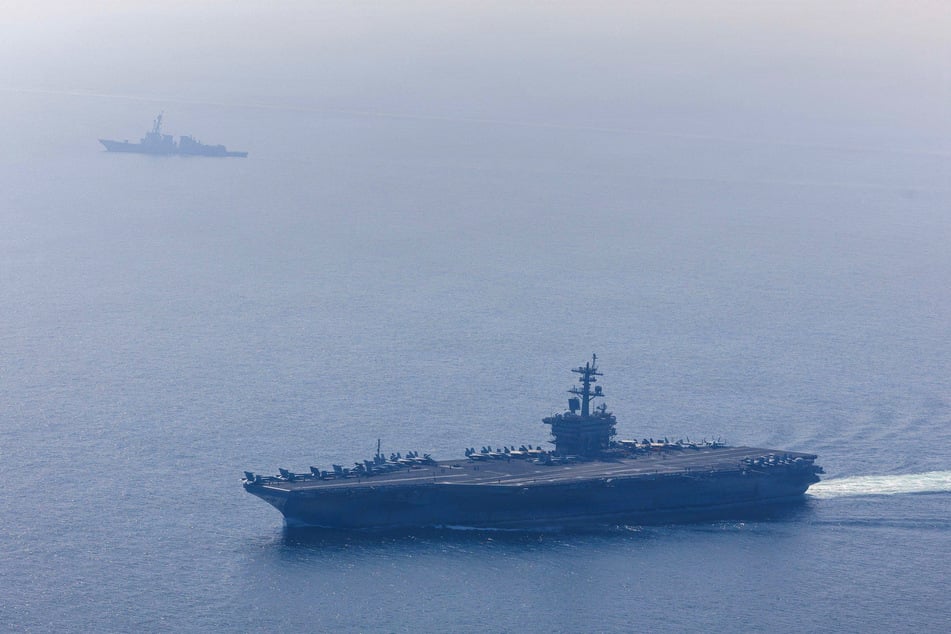 The US Navy's Nimitz-class aircraft carrier USS Abraham Lincoln and Arleigh Burke-class guided-missile destroyer USS Frank E. Petersen Jr. sail during an exercise in the Arabian Sea on February 6, 2026.