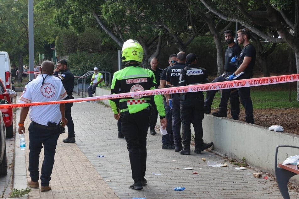 Israeli police and first responders gather at the scene of a reported stabbing attack in Holon in the southern suburb of Tel Aviv.