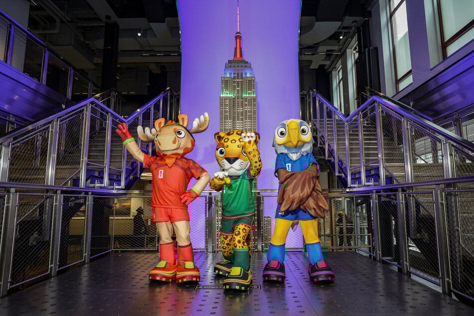 The FIFA World Cup 2026 mascots Maple, Zayu, and Clutch pose during a lighting ceremony marking 100 days until the tournament, at the Empire State Building in New York City on March 3, 2026.