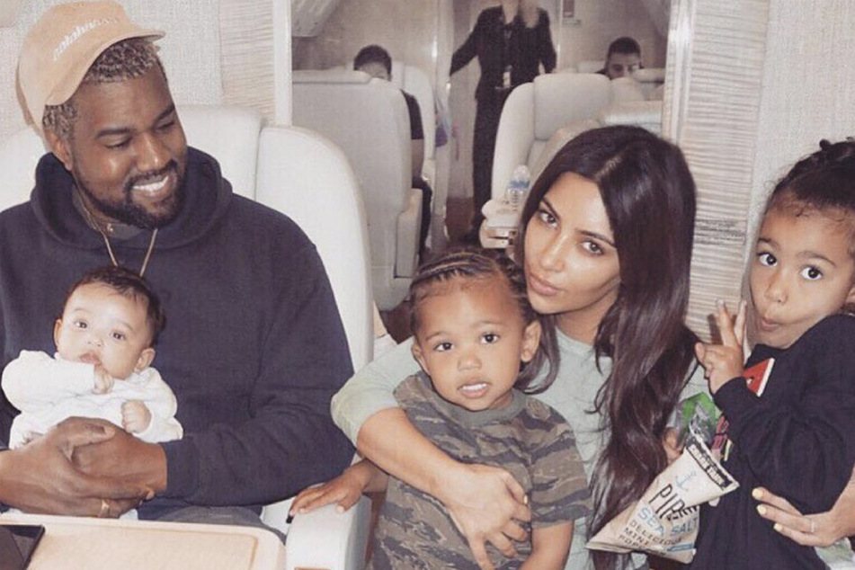 Kim Kardashian (r) posted a family picture with Kanye West and three of their children, North (l), Saint (m), and Chicago (r) in honor of the rapper's 44th birthday.