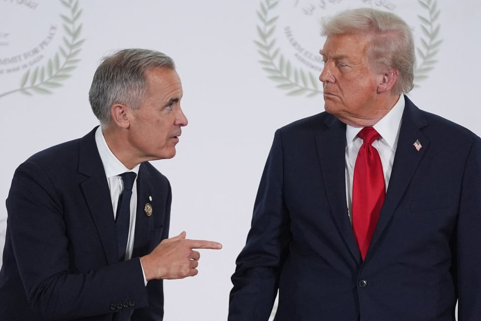 US President Donald Trump (r.) greets Canada's Prime Minister Mark Carney (l.) during a summit in Sharm el-Sheikh on October 13, 2025.