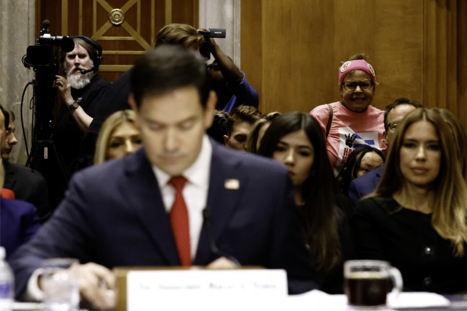 An activist demonstrates as Donald Trump's nominee for secretary of state, Senator Marco Rubio, testifies during his Senate Foreign Relations Committee confirmation hearing on January 15, 2025.