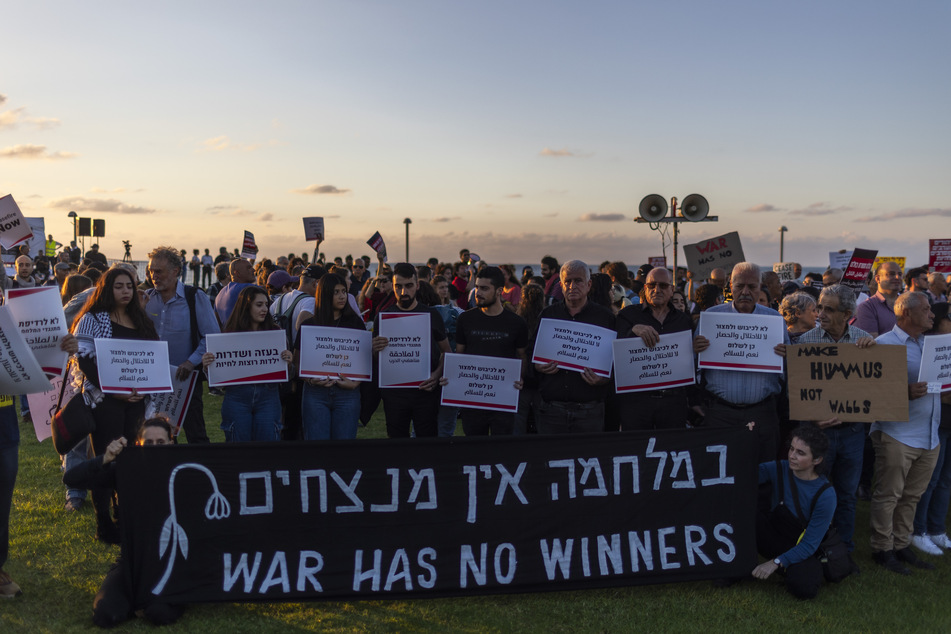 Israelis und Araber halten Plakate während einer Demonstration, um einen Waffenstillstand und die sofortige Freilassung der von der palästinensischen Terrororganisation Hamas entführten Geiseln zu fordern.