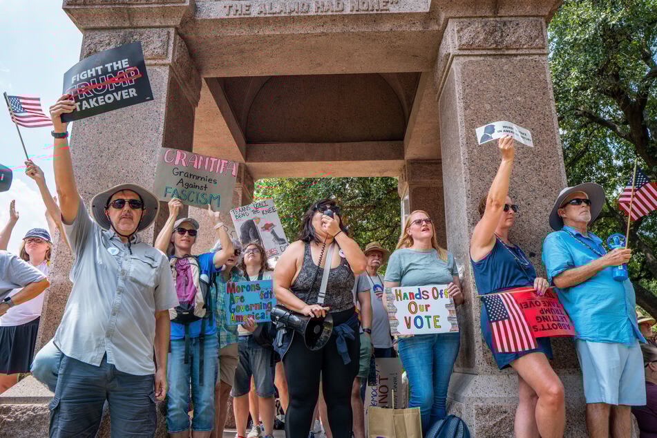 Texans rally during a "Stop the Trump Takeover" demonstration outside of the State Capitol in Austin on August 16, 2025.