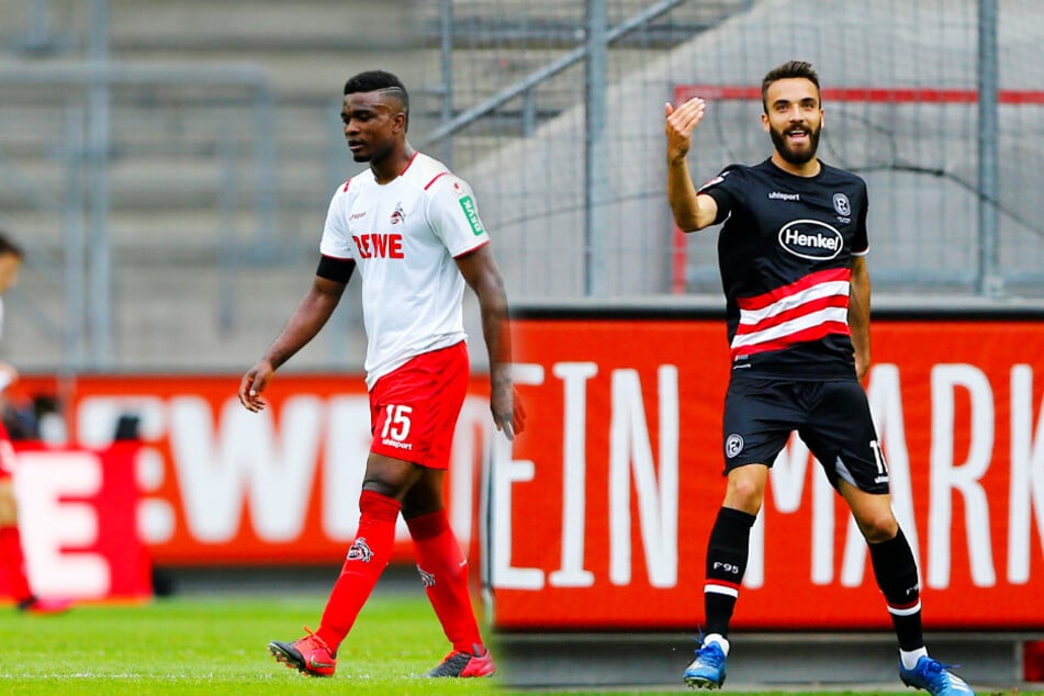 Kenan Karaman (r.) feiert seinen Treffer zum 1:0, während Kölns Jhon Cordoba betreten dreinschaut.