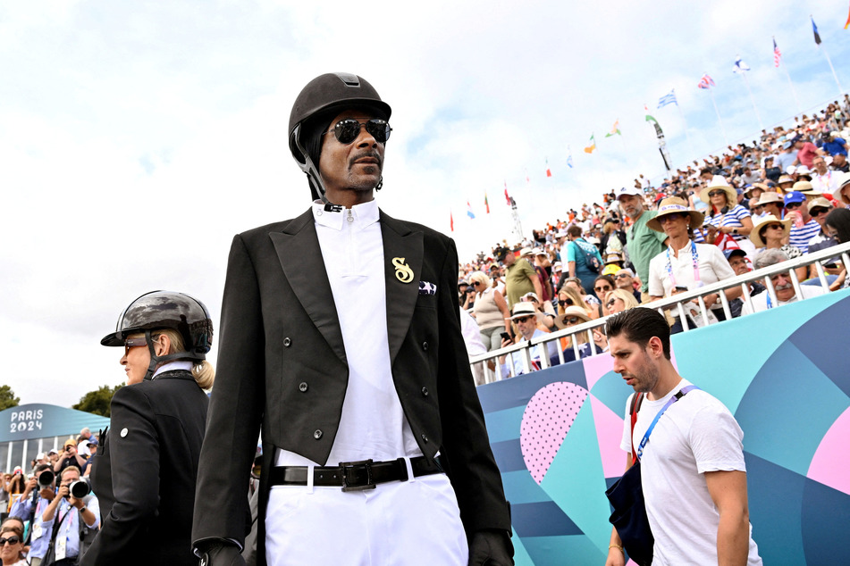 Snoop Dogg watches the Dressage Team Grand Prix Special at the Paris Olympics in Versailles, France.