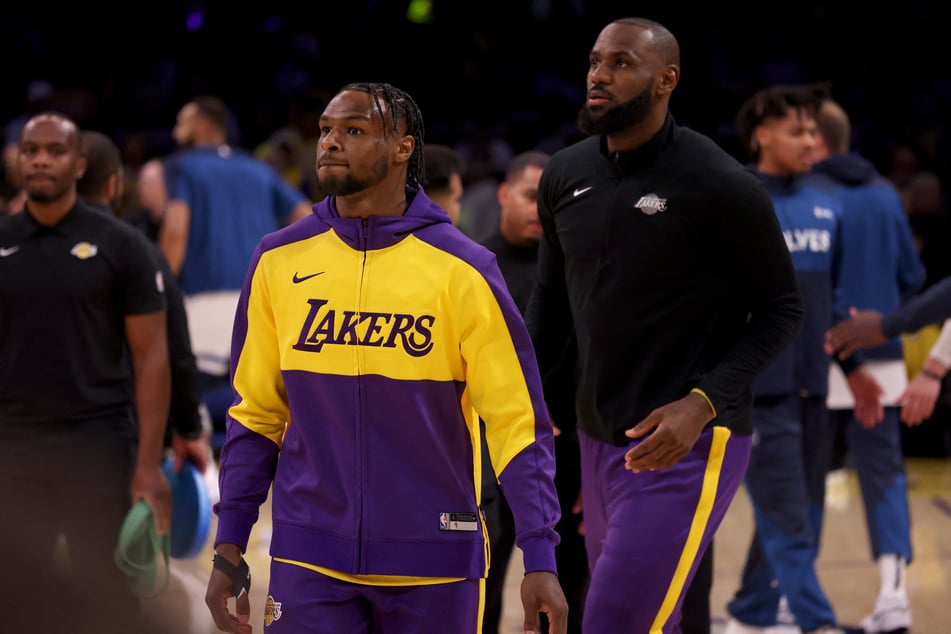 Los Angeles Lakers guard Bronny James (l.) and forward LeBron James (r.) warm up before a game against the Minnesota Timberwolves at Crypto.com Arena.