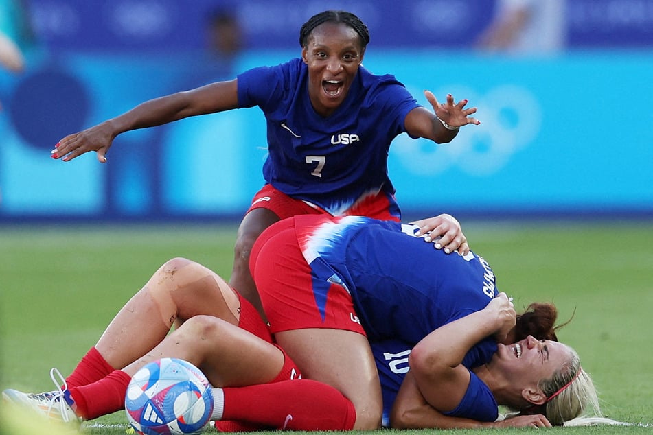 Crystal Dunn and Lindsey Horan hug winning goalscorer Mallory Swanson, who led the US to gold in the Olympic women's soccer final against Brazil.