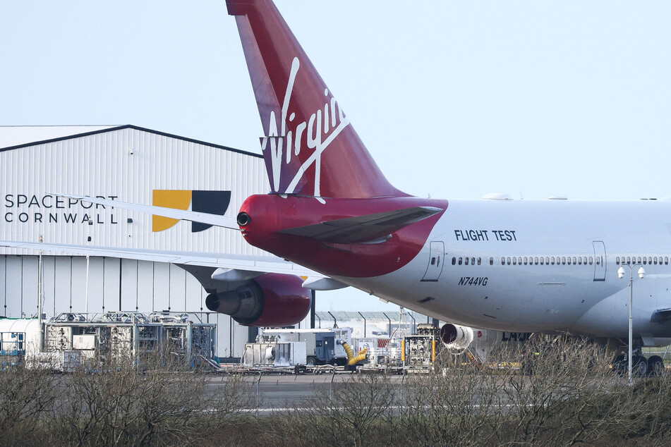 Cosmic Girl sits on the tarmac with Virgin Orbit's LauncherOne rocket attached at Spaceport Cornwall at Newquay Airport.