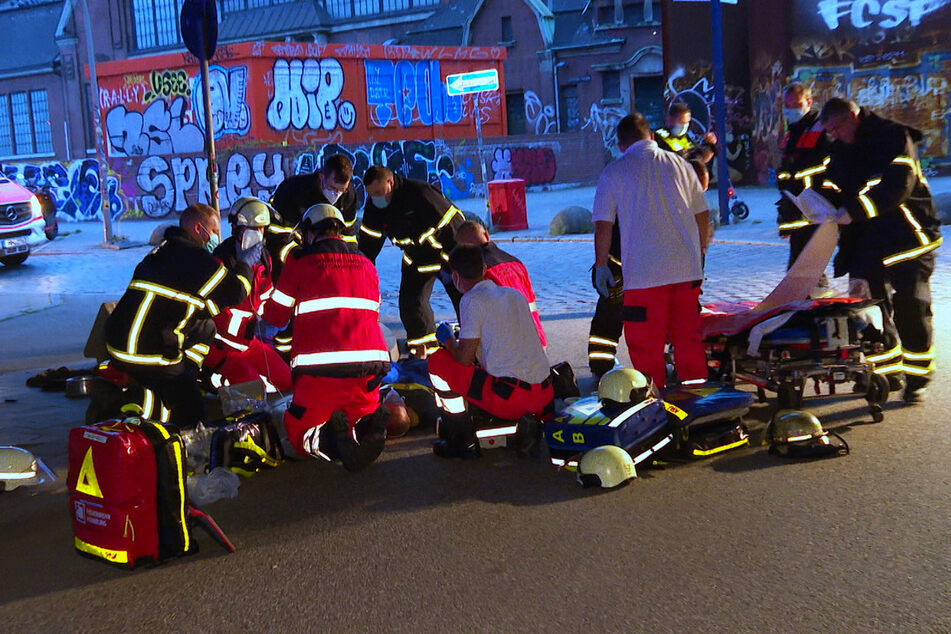 Rettungskräfte versorgen den schwer verletzten Mann, nachdem er im Schlaf von dem Lkw überrollt wurde.