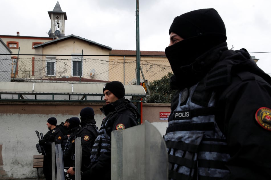 Turkish police stand guard outside the Italian Santa Maria Catholic Church in Istanbul after two masked gunmen were shooting during Sunday service on January 28, 2024.