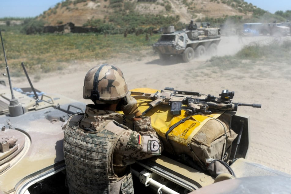 Afghanistan, Kundus: Bundeswehrsoldaten fahren 2011 während eines Einsatzes durch das Gelände.