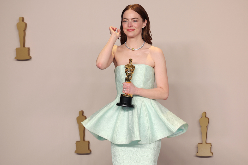 Emma Stone poses with the Best Actress Oscar for Poor Things at the 96th Academy Awards.