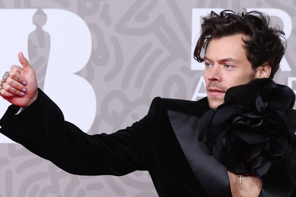 Harry Styles steps out at London Fashion Week in rare appearance – mullet and all!