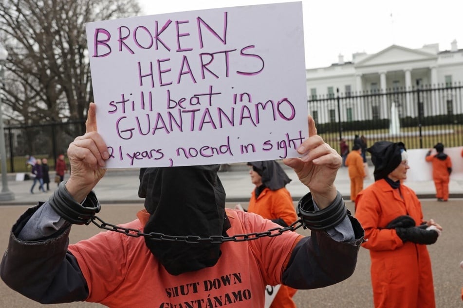 Activists in orange jumpsuits, representing the men who are still being held at Guantanamo Bay in Cuba, protest in front of the White House for the closure of the US detention facility.