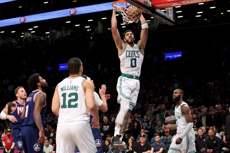 Boston's Jayson Tatum dunks on the Nets as his team sweep the playoff series.