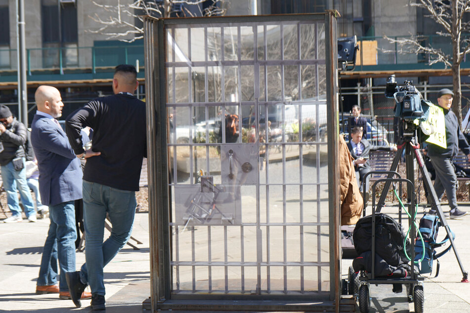 Someone erected a makeshift jail cell door in the center of a courtyard located just outside the courthouse.