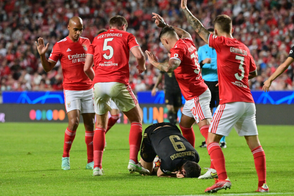 Robert Lewandowski (3.v.r.) liegt nach einem Kopfball-Duell gegen Jan Vertonghen (2.v.l.) am Boden.