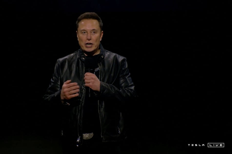 Tesla CEO Elon Musk speaks during an unveiling event for the company's robotaxi, robovan, and Optimus robots.