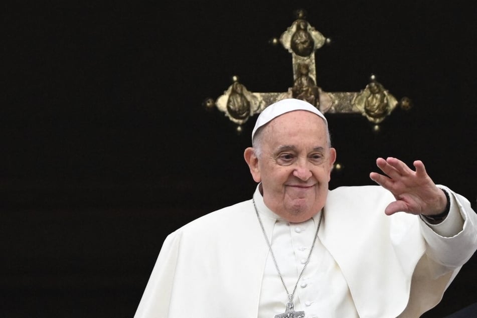 Pope Francis waves from the central loggia of St. Peter's Basilica during the Easter "Urbi et Orbi" message and blessing to the City and the World on March 31, 2024.