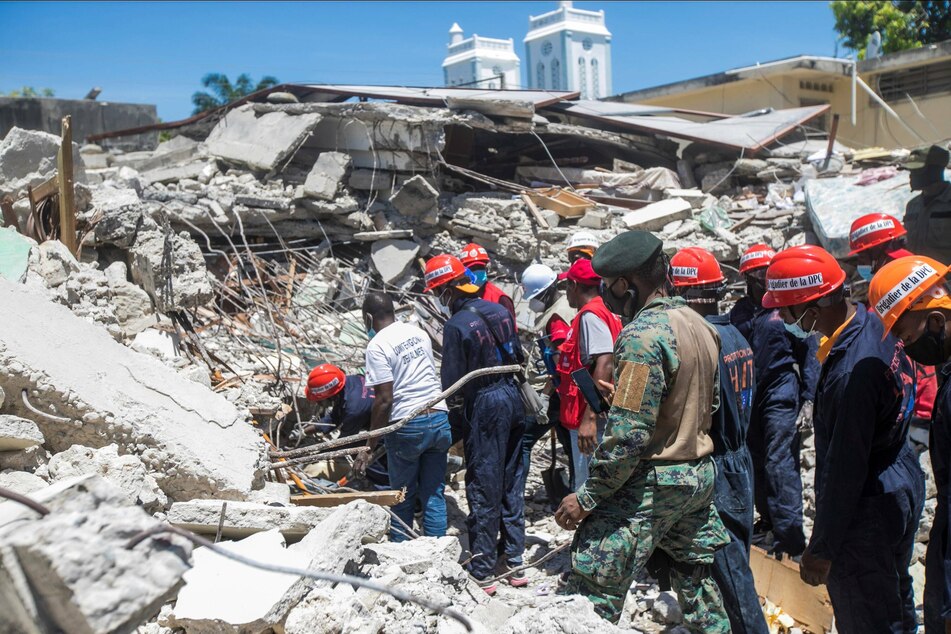 Emergency personnel carry out debris removal, as well as search and rescue work in Les Cayes.
