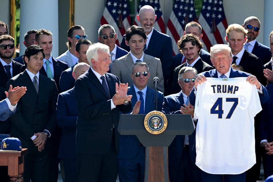 President Donald Trump holds a Los Angeles Dodgers jersey with his name and the number 47 as Dodgers owner Mark Walter (L) applauds during a ceremony to honor the 2025 World Series champions in the Rose Garden at the White House in Washington, DC, on Thursday.