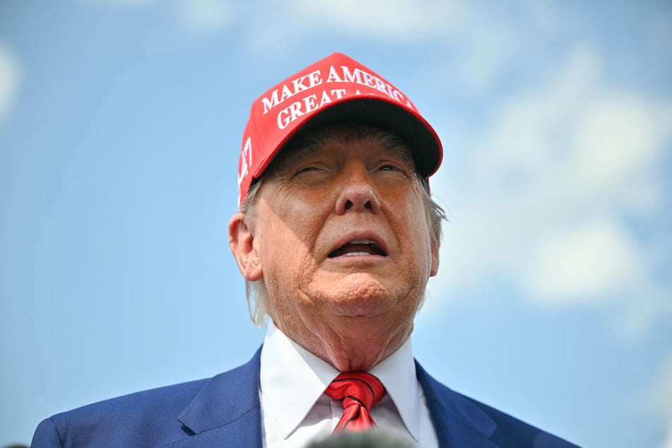 President Donald Trump speaks to the press upon arrival at Morristown Municipal Airport in Morristown, New Jersey, on Friday.