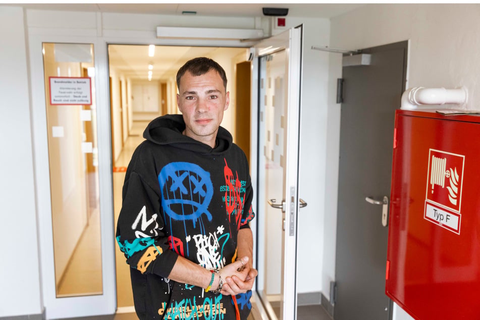 Auf gute Nachbarn! Anwohner Erik Glaß (34) im Hausflur des 13. Stocks.