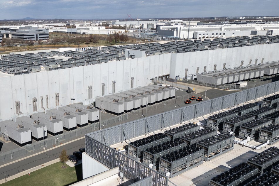 An aerial photo shows cooling vent fans on the roof next to generators on the lower level of a Digital Realty data center in Ashburn, Virginia, on November 12, 2025.