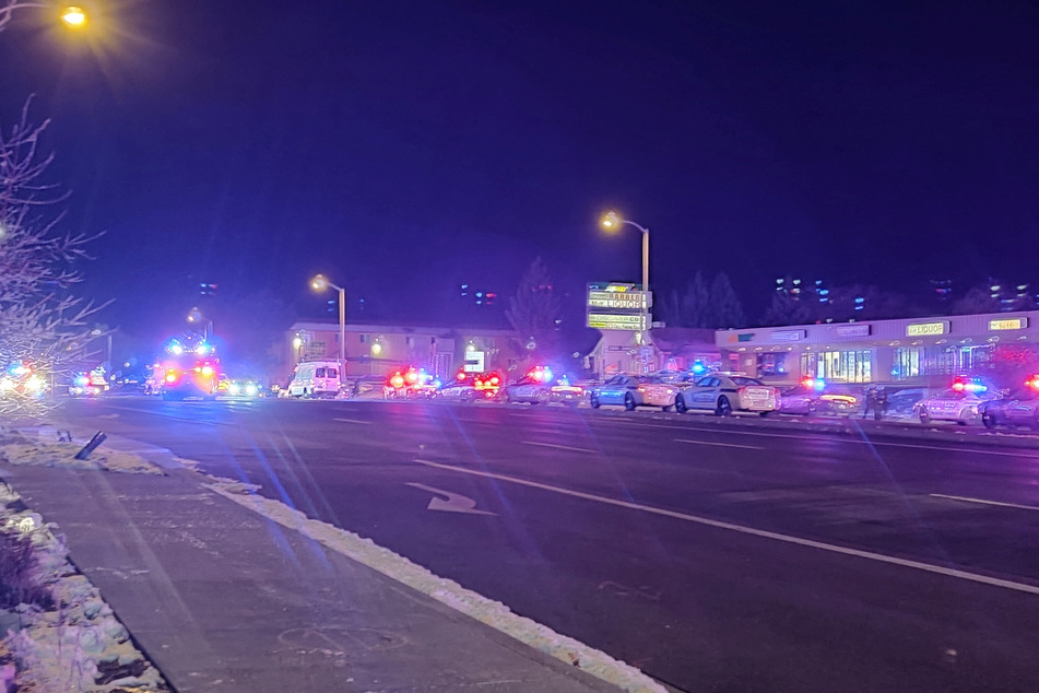 Police cars surround Club Q after a deadly mass shooting on Saturday night.