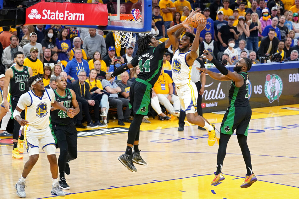 The Warriors' Andrew Wiggins flies into a slam dunk, on his way to a team-high 26 points.