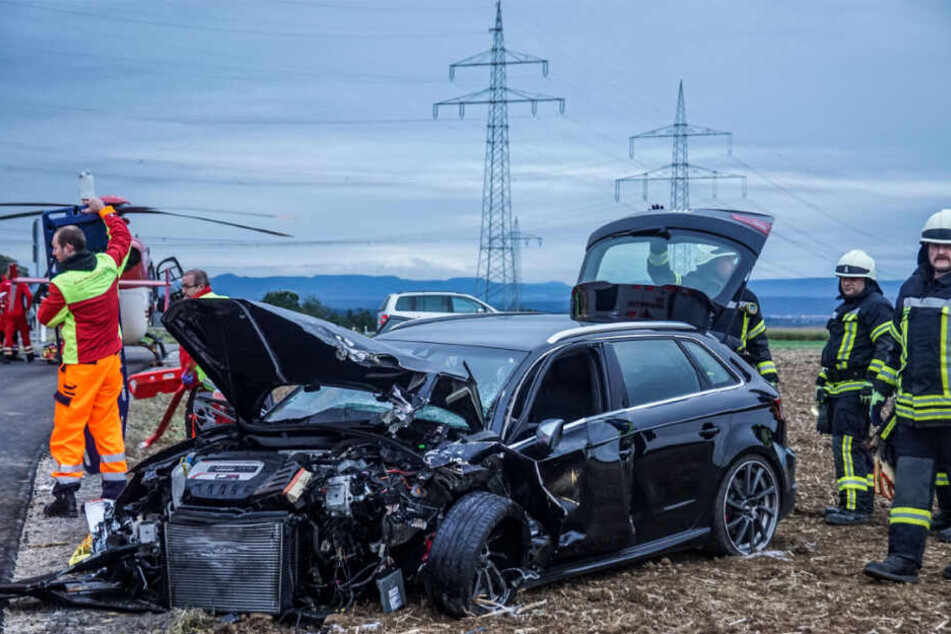 Rettungskräfte vor dem verunfallten Wagen.